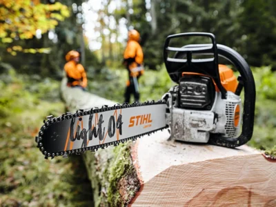 Stihl chainsaw on log of wood